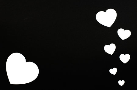 Paper hearts on a black background. Valentine's day background.の写真素材