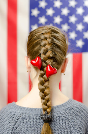 The hearts are woven into the hair of the red-haired girl.の写真素材
