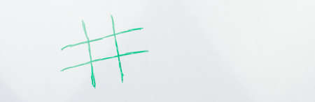 The hashtag symbol is drawn with a green felt-tip pen on a white school boardの写真素材