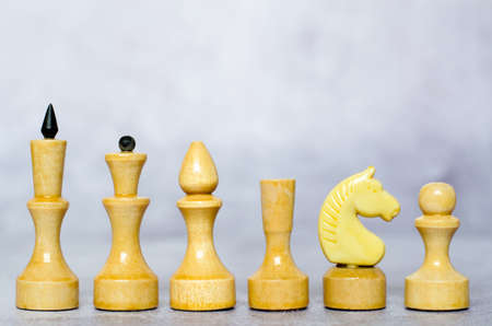 White chess pieces on a chessboard close up, side viewの写真素材