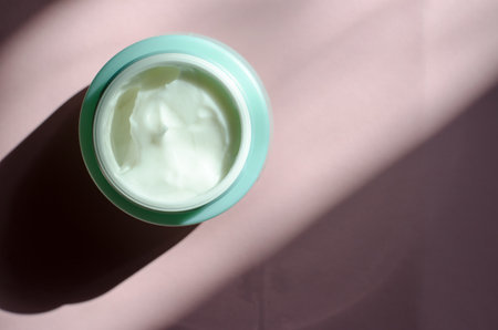 A jar of cream with harsh shadows, minimalism. Skin care conceptの写真素材