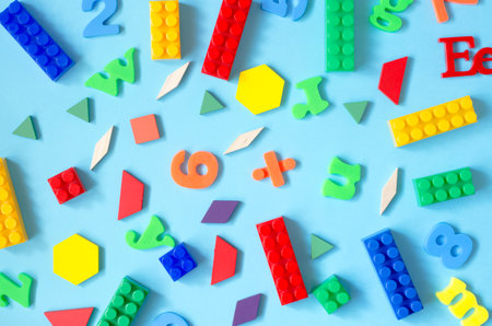 Background from letters of the English alphabet, numbers and a children's constructor. Child development and learning conceptの写真素材