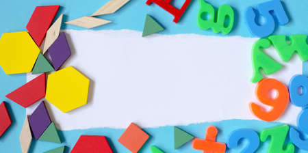 Background from letters of the English alphabet, numbers and a children's constructor with a place...