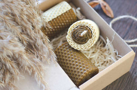 Handmade wax candles with honey scent in a gift boxの写真素材