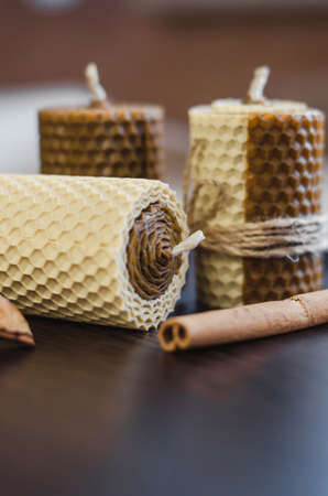 Handmade wax candles with honey aroma on dark wooden backgroundの写真素材