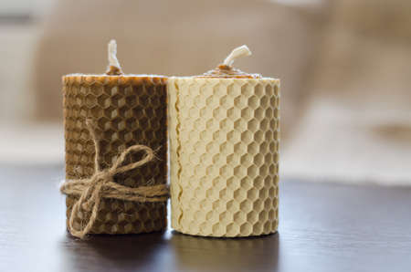 Handmade wax candles with honey aroma on dark wooden backgroundの写真素材