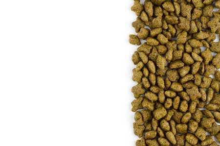 Dry cat food on white background with place for text