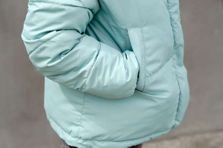 Woman's hand in the pocket of a stylish jacket close-up