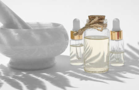 Natural essential oils in transparent bottles on a white background.の写真素材