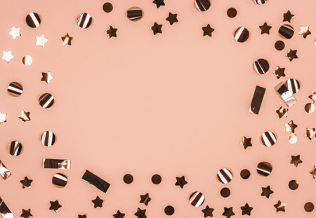 Festive background with place for text. Golden decorations on a pink background. Festive concept....