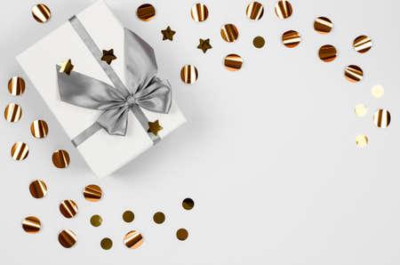Festive greeting card. Christmas festive background with place for text. Large gift box and sequins...