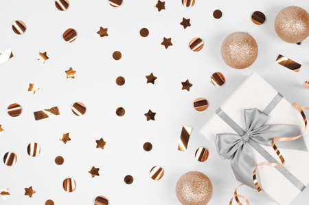Festive background with sparkles, Christmas balls, gift box and streamer. Christmas background