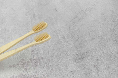 Two wooden toothbrushes on a concrete background with place for textの写真素材
