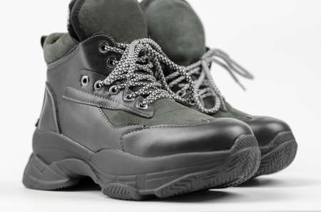 Warm unisex boots close up on white background, selective focus