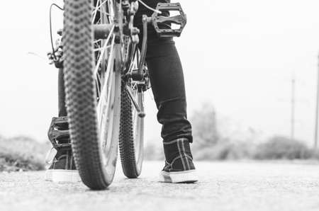 A ride on the bicycle. Healthy lifestyle concept. Rear view of unrecognizable teenager's legs and bike.の写真素材