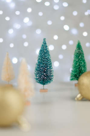 Christmas or New Year background. Toy green tree against the background of blurry lights of garlands. Christmas cardの写真素材