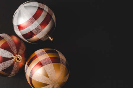 Golden Christmas decor on a black background, Christmas card. New Year's composition.の写真素材