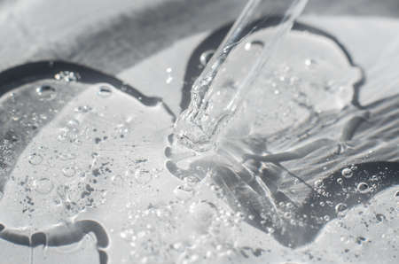 Close-up of the structure of the gel. Transparent cosmetic gel in a petri dish with a pipetteの写真素材
