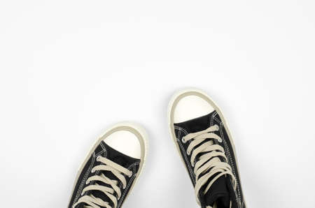 Top view of black sneakers on a white background, copy spaceの写真素材