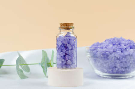 Lavender sea salt in a transparent bottle on a round podiumの写真素材