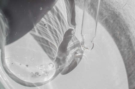 Laboratory research and development of body care cosmetics. Transparent cosmetic gel in a Petri...