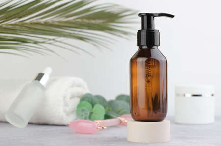 SPA composition. Amber bottle with a dispenser on the podium. massage set.の写真素材