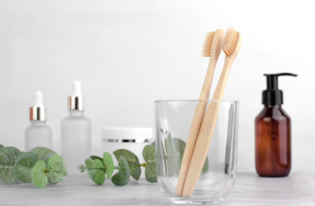 Two wooden toothbrushes in a transparent glass jar. oral care.の写真素材