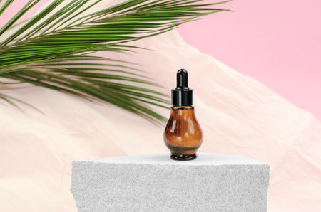 Natural hyaluronic serum in bottles with pipette. Natural essential oil or serum in a bottle with a pipette on a gray podium.の写真素材