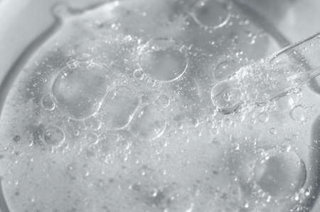 Laboratory research of cosmetic products. Transparent cosmetic aloe vera gel in a petri dish with a...