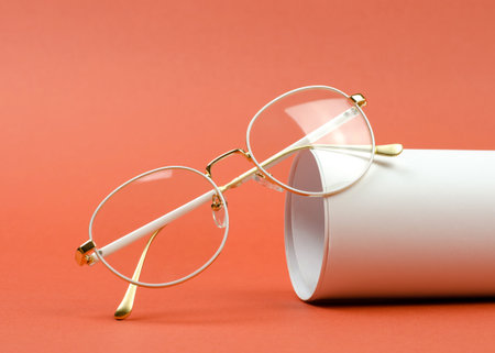 Stylish women's eyeglasses in a white frame on an orange backgroundの写真素材