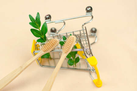 Two wooden toothbrushes on a shopping trolley, close-up