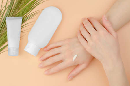 Organic cosmetics for skin care. A woman applies moisturizer to her hands. beauty concept