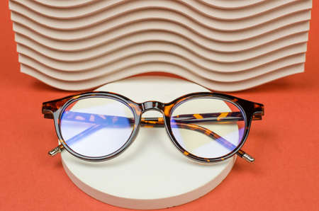 Stylish eyeglasses on a round podium. Leopard glassesの写真素材