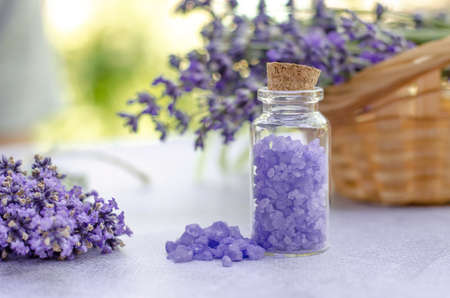 Lavender sea salt in a small transparent bottle and fresh lavender flowers. Lavender salt for spa treatmentsの写真素材