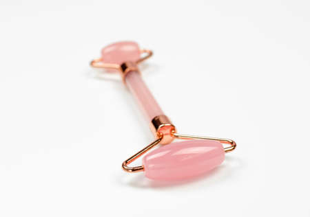 Quartz roller for gua sha massage on a white background, selective focusの写真素材