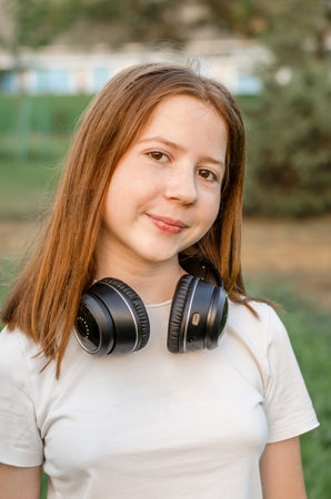 Portrait of a 12 year old red-haired teenage girl in nature