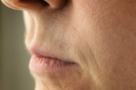 Female mustache close-up. Mustache above the upper lip of a woman, close-up, selective focusの写真素材