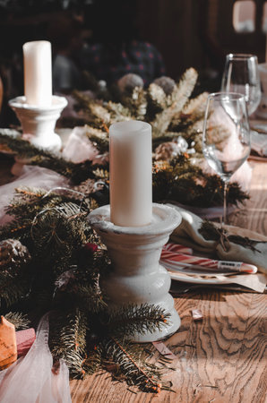 Christmas table decoration. Candle on a decorated Christmas tableの写真素材