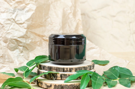 The concept of natural cosmetic products. Moisturizer black packaging mockup. Closed black jar of moisturizer.の写真素材