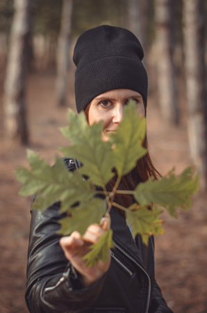 Portrait of a beautiful young woman in a pine forestの写真素材