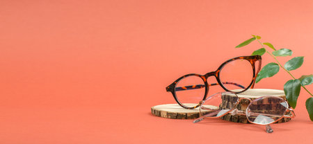 Stylish round eyeglasses on a wooden podium. glass sale banner