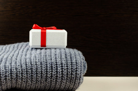 Gift box on a knitted sweater, side view, copy spaceの写真素材