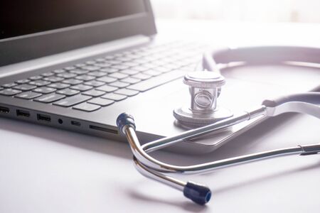 stethoscope lay on  computer with pen and glasses, documents. work spase of doctor.の写真素材