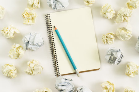 new ideas concept. notebook, paper balls, colorful pencils on white background.copy spaceの写真素材