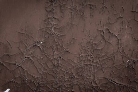old cracked brown paint on a door with white gaps. texture, background. copy space