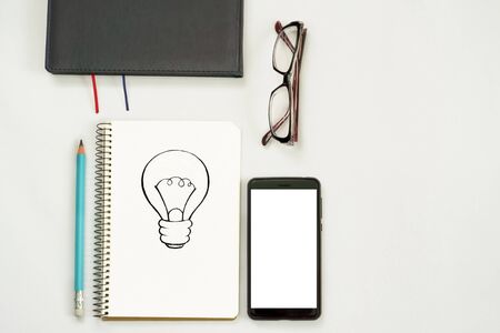 new ideas concept. notebook with three exclamation marks, paper balls, smartphone, laptop, pencil. copy spaceの写真素材