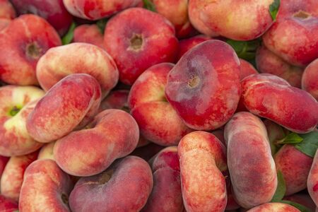 Flat nectarine, donut saturn peach at street fruit vegetables market, ecological organic food from...