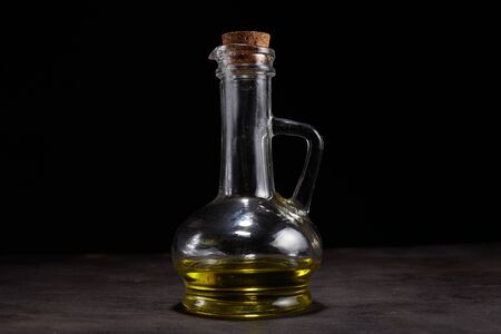 Extra virgin healthy Olive oil with fresh olives on dark wooden backgroundの写真素材