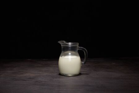 Glass of fresh milk on dark backgroundの写真素材