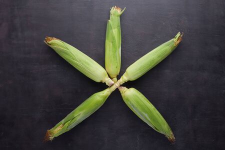 Corn on a dark tree background close-up with copyspace.の写真素材
